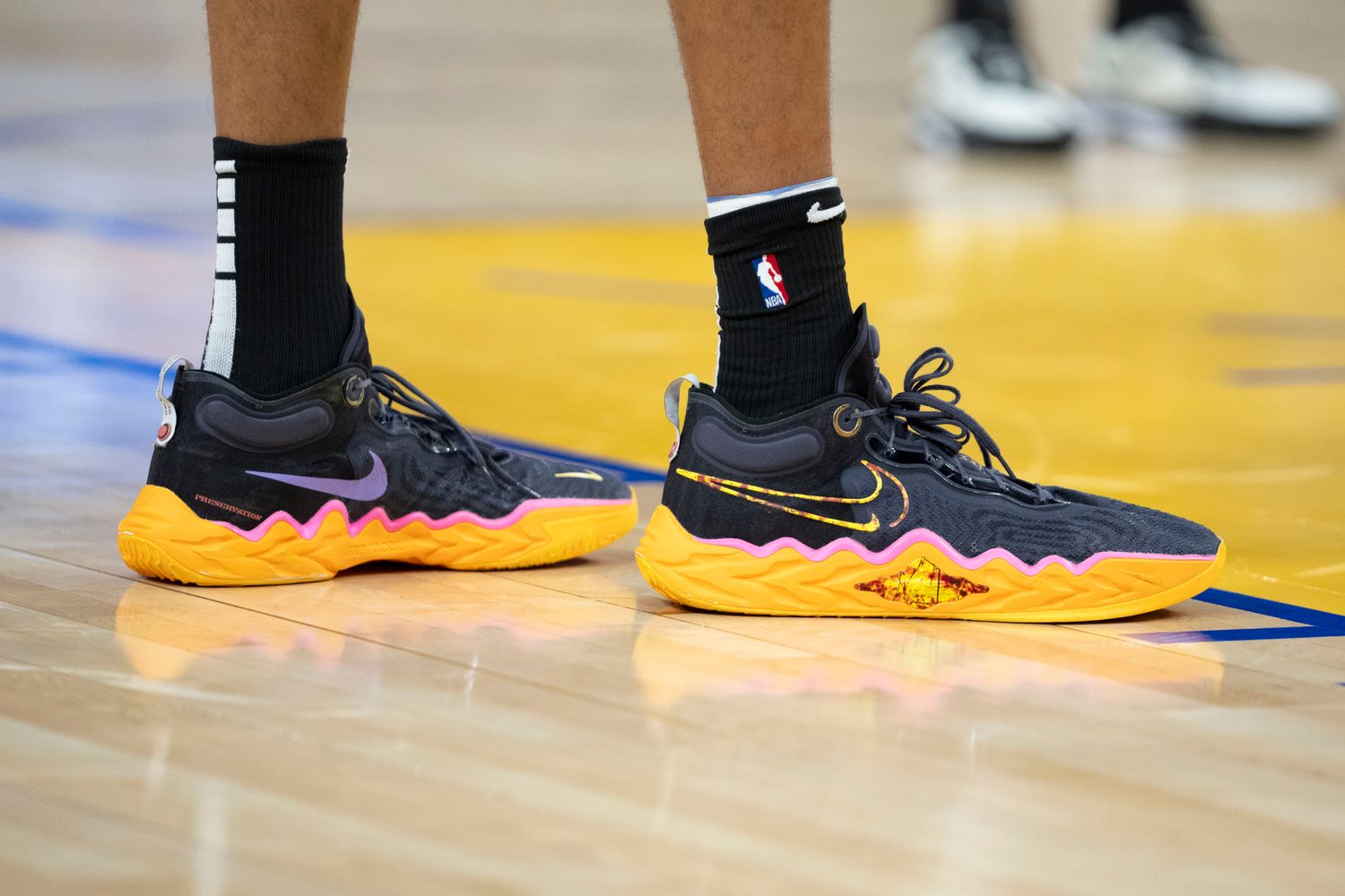 San Antonio Spurs center Victor Wembanyama's black and orange Nike shoes.